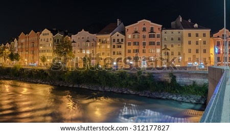 MARIA HILFER-ST. NICOLAS District, INNSBRUCK, AUSTRIA-August 22, 2015: A row of houses, apartments, offices, hotels, restaurants, along the left bank of river Inn at night