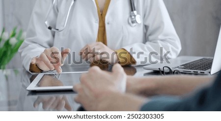 Similar – Image, Stock Photo Close up of female hands typing on laptop keyboard at home near his unrecognizable girlfriend. Business, working from home, studying online concept.