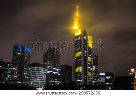 Evening panorama of Frankfurt Skyline (skyscrapers in downtown) in cloudy weather at night, view from Main river - architecture background, Frankfurt, Germany