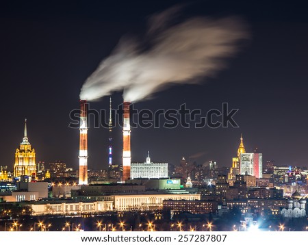 Panorama of Moscow city, capital of Russia, at night - view from Sparrow hills to the Ostankino TV tower, Russian government building, two soviet skyscrapers and power station with smoking pipes