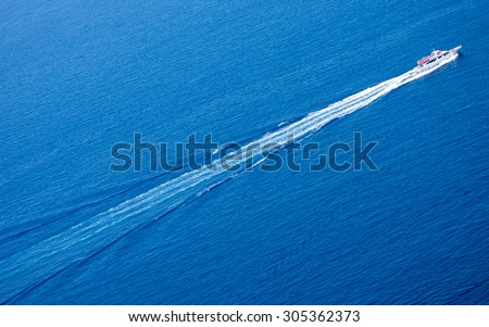 Trace from high-speed yacht over deep-blue sea surface. Ligurian sea, Italy.