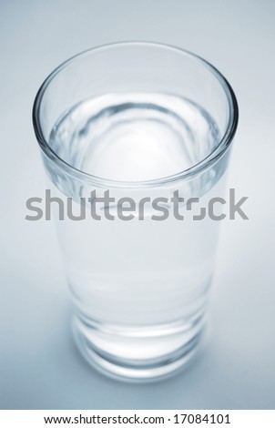 Fresh cool glass of water on a blue background