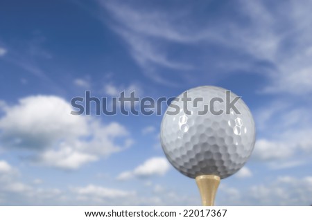 Golf ball on a tee against a beautiful sky background