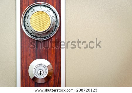 Full picture of safe door with password ring and key insert hole on wood pattern decoration