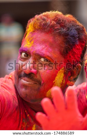 Colorful man face during the Holi celebration on March 27, 2013, Mumbai, Maharashtra, India. Holi is the most celebrated religious color festival in India.