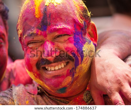 Colorful man face during the Holi celebration on March 27, 2013, Mumbai, Maharashtra, India. Holi is the most celebrated religious color festival in India.