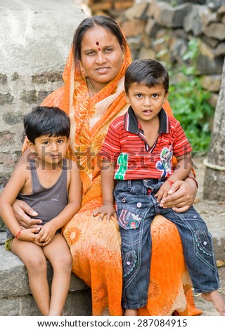 MAHARASHTRA, INDIA SEPTEMBER 22, 2011: Indian rural mother with children, SEPTEMBER 22, 2011, rural village, Salunkwadi, Ambajogai, Beed, Maharashtra, India