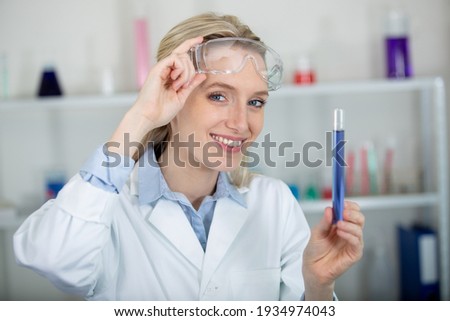 Similar – Image, Stock Photo Young scientist pipetting solution.