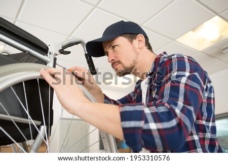 Similar – Image, Stock Photo Woman fixing bike in workshop