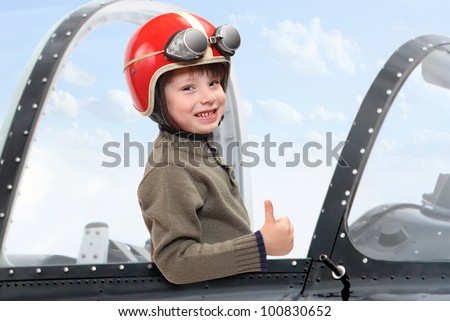 Little pilot in cockpit of a vintage plane. Close up with shallow DOF.