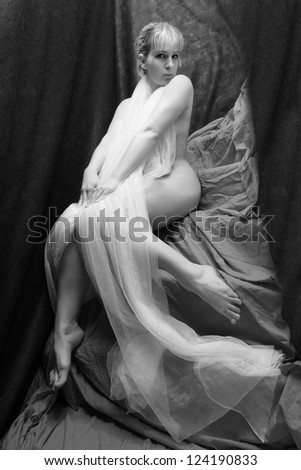 Flirty girl in net veil. Vintage style black and white photography.