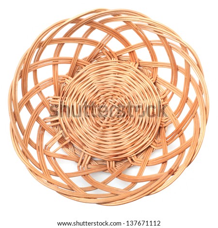 An empty wicker dish on white background. Traditional rustic handmade product.