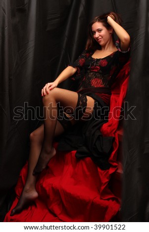 Low key lighting studio shot young attractive women in black sexy lingerie on red background