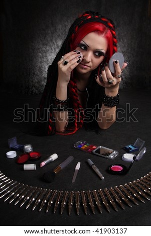 Portrait of bizarre red hair Gothic Girl with puff-box and cosmetics accessories. Low key studio shot. Great for calendar.
