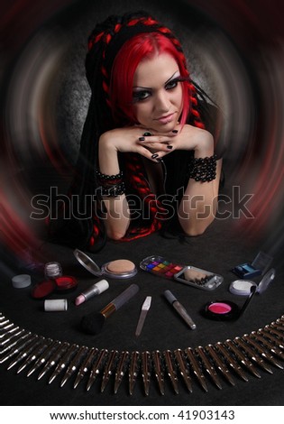 Portrait of bizarre red hair Gothic Girl with cosmetics accessories. Low key studio shot. Great for calendar.