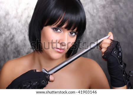 Beautiful girl with a dagger on a black background. Great for calendar.