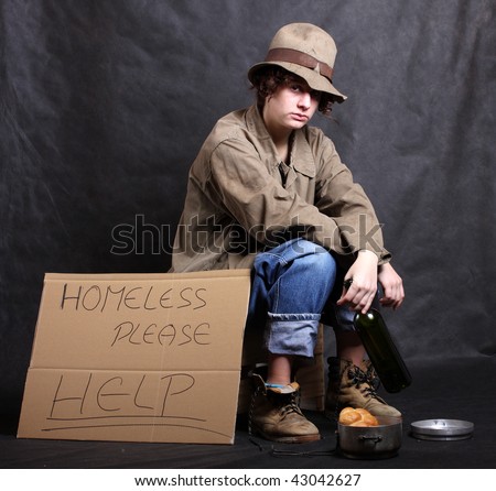 Young homeless poor alcoholic in depression. Low key studio shot. Great for charity brochures and advertisements.