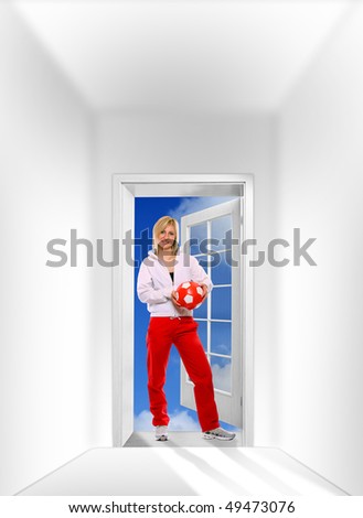 Beautiful sporty girl with soccer ball in opened door against the sky. Great for fitness brochure and advetisements.