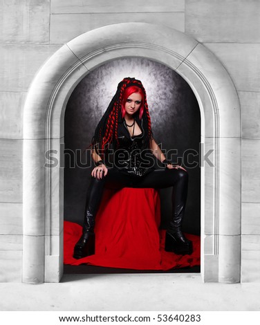 Bizarre red hair Gothic Girl in stone dungeon. Great for calendar and Halloween advertisement.