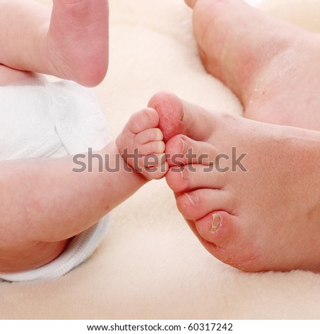 Baby feet and mother\'s feet. Little and big.