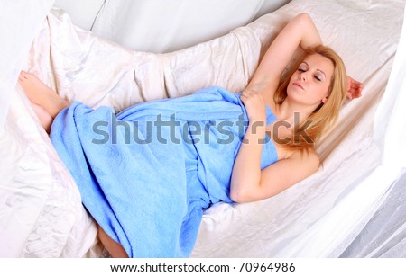 Beautiful young woman sleeping in a vintage bedroom.