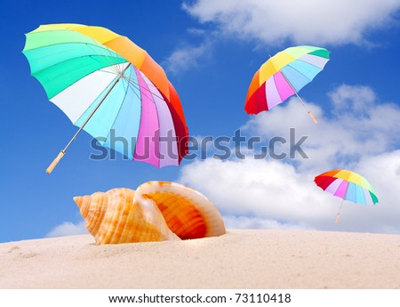 Tropical beach with rainbow umbrellas flying in stormy wind. Stormy weather (end of holidays) metaphor.