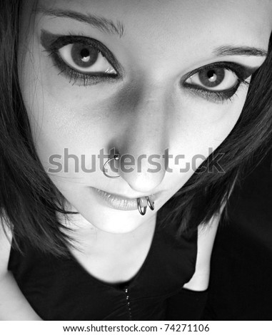 Monochrome low key portrait of attractive gothic woman with big eye.