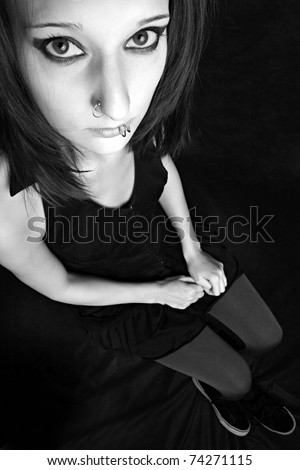 Monochrome low key portrait of attractive gothic woman with big eye.