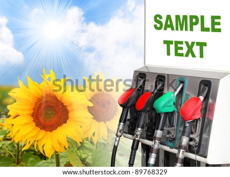 Gas station and sunflowers field. Ecology concept. Space for your text.