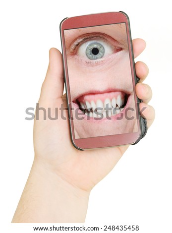 Mobile phone with eye and teeth. Big Brother is watching you. Internet safety concept.