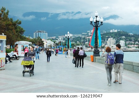 YALTA, CRIMEA,UKRAINE - MAY 25: unidentified tourists are walking along seafront of Yalta city, most famous ukrainian Black Sea resort, on May 25,2012 in Yalta, Crimea, Ukraine