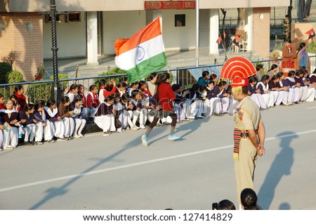 ATTARI, INDIA - DECEMBER 7:Indian people celebrating at the Indian - Pakistani border during daily border closing ceremony at December 7, 2012 in Attari, Punjab, India