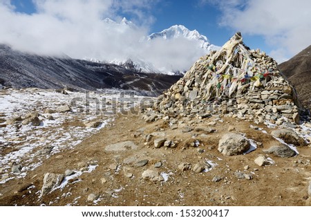 Stone cairn with religious tibetan flags marks a sacred buddhist place,Everest Base Camp region,Nepal