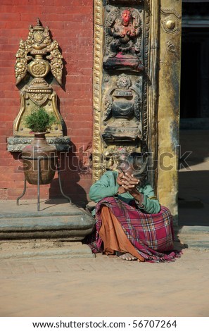 BHAKTAPUR,NEPAL - DECEMBER 29 : Old poor woman asks for money December 29, 2007 in Bhaktapur, Nepal. Bhaktapur is one of the most popular landmarks in Asia, receiving millions of visitors annually.