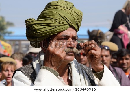 PUSHKAR, INDIA - NOVEMBER 14: Unidentified old man shows his moustache at moustache competition at Pushkar camel fair on November 14, 2013 in Pushkar, Rajasthan, India.