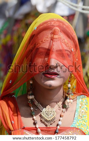 PUSHKAR, INDIA - NOVEMBER 12:Unidentified gay (hijra) dressed as woman at camel fair on November 12,2013 in Pushkar,India.In South Asia culture, hijras are people who have feminine gender identity