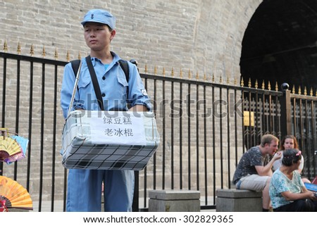 China. On July 29, 2015, xi \'an drum and hui street, in a special uniform of college students is to visitors from all over the world to sell old Popsicle. He is a work-study programs.