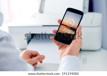 Man sending a photo to wireless printer. Cloud print concept