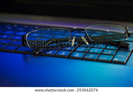 Eyeglasses on laptop keyboard. The concept of caring for eyes and take breaks when working with your computer