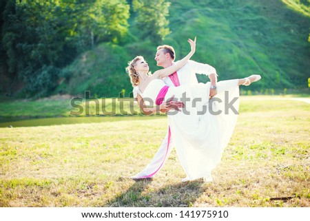 Bride and groom dancing the tango in nature. Wedding dance in the open air. Dancers love flying.