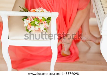 Wedding bouquet of flowers near the bride who plays the piano