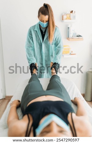 Similar – Image, Stock Photo Physiotherapist stretching leg of patient in medical room