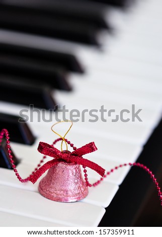 Closeup of little bell on piano keys. Selective focus