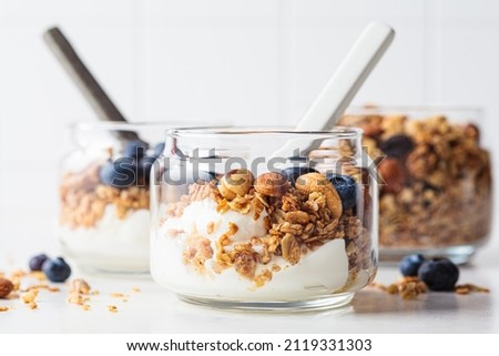 Similar – Image, Stock Photo A muesli with yoghurt and fresh fruit in a preserving jar on the breakfast table