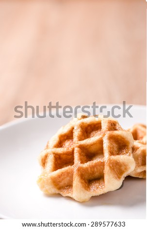 Waffles in bowl on wood table