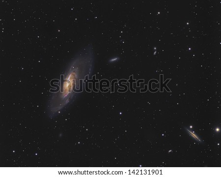 Spiral Galaxies Messier 106 and NGC4217 - Two spiral galaxies (one face-on and one edge-on) about 24 million light years away in the constellation Canes Venatici