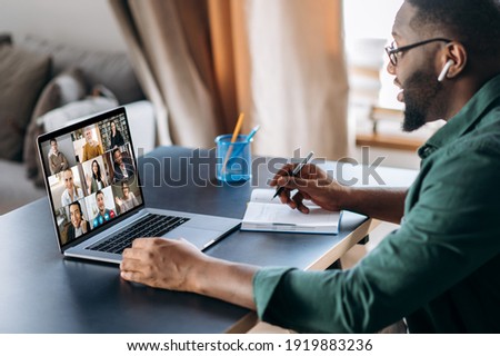 Online business briefing. Male African American employee speak on video call with diverse multiracial colleagues, on laptop screen diverse business people, meeting online, group brainstorm