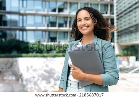 Similar – Image, Stock Photo Lovely curly woman with combed hair, keeps hand in pocket