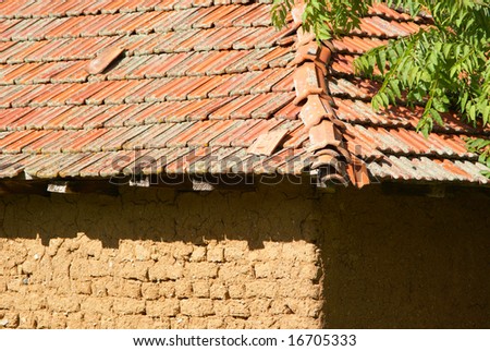 Mud brick rural building and red tiled roof in rural Macedonia