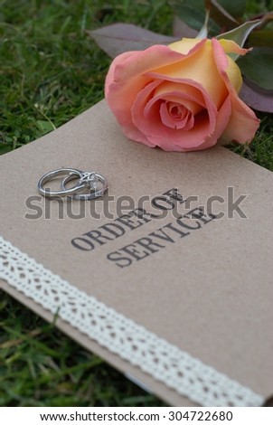 Order of Service, with wedding rings and rose